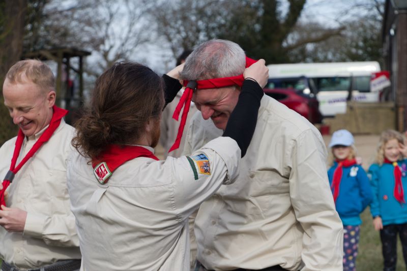 A picture of an adult volunteer being invested
